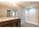Bathroom features a double vanity, neutral color palette, and a glass-enclosed shower at 7486 Tuscan Bay Cir, Wesley Chapel, FL 33545