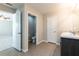 Bathroom features a double vanity, neutral color palette, separate toilet room and multiple entry doors at 7486 Tuscan Bay Cir, Wesley Chapel, FL 33545