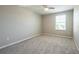 Carpeted bedroom with natural light from the window and neutral walls at 7486 Tuscan Bay Cir, Wesley Chapel, FL 33545