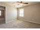 Neutral bedroom with large window, ceiling fan, and wall to wall carpeting at 7486 Tuscan Bay Cir, Wesley Chapel, FL 33545