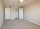 Carpeted bedroom featuring a closet and connection to the hallway at 7486 Tuscan Bay Cir, Wesley Chapel, FL 33545