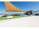 The community area features lawn chairs, a covered stage and movie screen, and picnic tables at 7486 Tuscan Bay Cir, Wesley Chapel, FL 33545