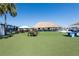 A beautiful community area with a tiki hut, picnic tables and open lawn at 7486 Tuscan Bay Cir, Wesley Chapel, FL 33545