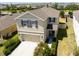 Two-story home featuring a two-car garage, manicured lawn, and neutral stucco exterior at 7486 Tuscan Bay Cir, Wesley Chapel, FL 33545