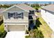 Charming two-story home with a well-maintained lawn, two-car garage, and coordinated exterior colors at 7486 Tuscan Bay Cir, Wesley Chapel, FL 33545