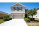 Well-maintained two-story home featuring a two-car garage and meticulously landscaped front yard at 7486 Tuscan Bay Cir, Wesley Chapel, FL 33545