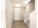 Bright foyer with tile flooring, leading to stairs, and a view of the front door with sidelight at 7486 Tuscan Bay Cir, Wesley Chapel, FL 33545
