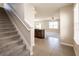Inviting foyer with staircase, tile flooring, natural light, and open layout, leading to the kitchen at 7486 Tuscan Bay Cir, Wesley Chapel, FL 33545