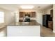 Spacious kitchen island with granite countertops and a full view of the kitchen appliances at 7486 Tuscan Bay Cir, Wesley Chapel, FL 33545