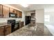 Modern kitchen featuring stainless steel appliances, granite countertops, and dark wood cabinets at 7486 Tuscan Bay Cir, Wesley Chapel, FL 33545