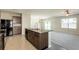 Modern kitchen featuring stainless steel appliances, granite countertops, and open layout to living area at 7486 Tuscan Bay Cir, Wesley Chapel, FL 33545