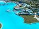An aerial view of a lagoon's swim-up bar, pool, seating areas, and beach at 7486 Tuscan Bay Cir, Wesley Chapel, FL 33545