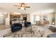 Open-concept living area showcasing modern furniture, a stylish rug, and seamless flow into the kitchen and dining spaces at 7486 Tuscan Bay Cir, Wesley Chapel, FL 33545