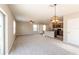 Bright open-plan living room with modern lighting and a view into the kitchen area at 7486 Tuscan Bay Cir, Wesley Chapel, FL 33545
