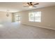 Spacious living room with ceiling fan, bright natural light, and access to outdoor space at 7486 Tuscan Bay Cir, Wesley Chapel, FL 33545