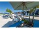 Pool area featuring cabanas, lounge chairs and palm trees at 7486 Tuscan Bay Cir, Wesley Chapel, FL 33545