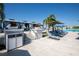 Pool area featuring cabanas, lounge chairs and palm trees at 7486 Tuscan Bay Cir, Wesley Chapel, FL 33545