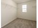 Bright walk-in closet featuring a window and white wire shelving for ample storage at 7486 Tuscan Bay Cir, Wesley Chapel, FL 33545