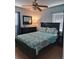 Cozy bedroom with wood-look floors, ceiling fan and a mirrored dresser at 7503 N Howard Ave, Tampa, FL 33604