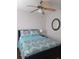 Comfortable bedroom featuring wood-look floors and ample natural light at 7503 N Howard Ave, Tampa, FL 33604