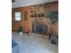 Cozy stone fireplace and wood paneling enhance the charm of the living space at 7503 N Howard Ave, Tampa, FL 33604