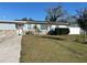 Charming single-story home with a stone accent wall and well-maintained lawn at 7503 N Howard Ave, Tampa, FL 33604