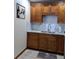 Charming kitchen area with wooden cabinets and granite countertops, perfect for a functional space at 7503 N Howard Ave, Tampa, FL 33604