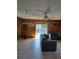 Spacious living room with wood paneling, access to pool, and comfortable seating at 7503 N Howard Ave, Tampa, FL 33604