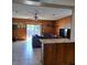 Open-concept living room with wood paneling, ceiling fan, and access to the outdoor pool area at 7503 N Howard Ave, Tampa, FL 33604