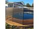 Tranquil pool enclosed by a safety fence, set in a well-maintained backyard at 7503 N Howard Ave, Tampa, FL 33604