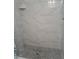 Newly renovated shower with pebble floor and stylish tile surround at 7503 N Howard Ave, Tampa, FL 33604