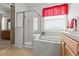 Bathroom featuring a glass enclosed shower, garden tub, and ceramic tile floors at 8704 Sandy Plains Dr, Riverview, FL 33578