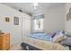 Comfortable bedroom featuring a double bed, dresser, and ample natural light at 8704 Sandy Plains Dr, Riverview, FL 33578