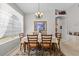 Bright dining room featuring a large window, a table set for six, and a decorative chandelier at 8704 Sandy Plains Dr, Riverview, FL 33578