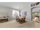 Open-concept dining area with neutral walls and carpet, perfect for entertaining at 8704 Sandy Plains Dr, Riverview, FL 33578