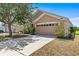 Charming single-story home with well-maintained lawn and a spacious two-car garage at 8704 Sandy Plains Dr, Riverview, FL 33578