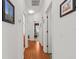 Hallway with light wood floors and neutral walls lead to the bedrooms and bathrooms at 8704 Sandy Plains Dr, Riverview, FL 33578