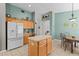 Open-concept kitchen featuring tile floors, an island, and modern appliances at 8704 Sandy Plains Dr, Riverview, FL 33578
