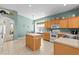 Bright kitchen with an island, tile flooring, and natural light at 8704 Sandy Plains Dr, Riverview, FL 33578