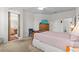 Neutral toned main bedroom has a ceiling fan, TV, neutral carpet and ensuite bath at 8704 Sandy Plains Dr, Riverview, FL 33578