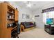 Office with a desk, futon, television, and natural light at 8704 Sandy Plains Dr, Riverview, FL 33578