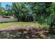 The spacious backyard features mature trees and a shed, providing a private outdoor space at 907 Tyner St, Plant City, FL 33563