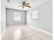 A bedroom featuring tile flooring, a ceiling fan, and two windows at 907 Tyner St, Plant City, FL 33563