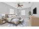 This bedroom features tile flooring, ceiling fan, a bed, and windows at 907 Tyner St, Plant City, FL 33563