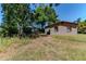 Rear view of house shows the backyard and proximity to surrounding greenery at 907 Tyner St, Plant City, FL 33563
