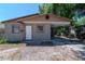 Single-story home featuring a tan exterior, a covered carport, and a white front door at 907 Tyner St, Plant City, FL 33563