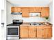 This kitchen features stainless steel appliances, wooden cabinets and double sinks at 907 Tyner St, Plant City, FL 33563