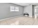 Spacious living room with light gray walls, tile floors, and a bench with a throw pillow at 907 Tyner St, Plant City, FL 33563