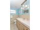Well-lit bathroom featuring a vanity and a large mirror at 9205 Ledgestone Ln, Port Richey, FL 34668