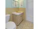 Bathroom with yellow and teal tiling and a coordinating vanity at 9205 Ledgestone Ln, Port Richey, FL 34668
